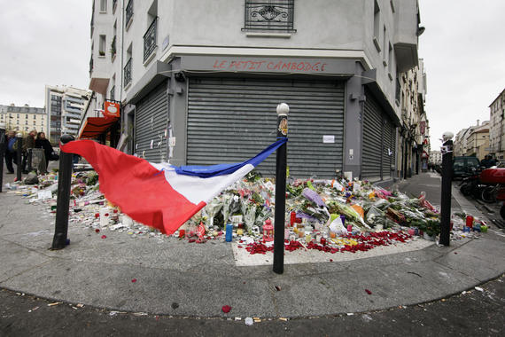 16 Nov 2015, Paris, France --- 16 November 2015  Paris, France Mourners lay flowers and light candles in front of Le Petit Cambodge restaurant in central Paris where people were gunned down. In a series of acts of violence, some 129 people were killing in shootings and suicide bombing. ISIL or islamic state claimed the responsibility. --- Image by © Leo Novel/Corbis